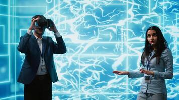 Tech experts presenting VR headset and AI tech during summit presentation, exploring successful implementation of artificial intelligence and virtual reality in driving forward businesses, camera A photo