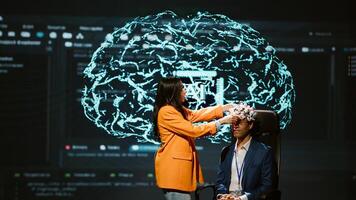 Company CEO using summit as platform to launch latest AI EEG headset product. Neuroscientist doing demonstration at forum in front of business leaders interested in artificial intelligence, camera A photo