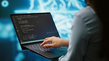 Engineer using notebook to maintenance artificial intelligence neural networks. Close up shot of IT expert using AI system aiding in processing and transmitting information, camera A photo