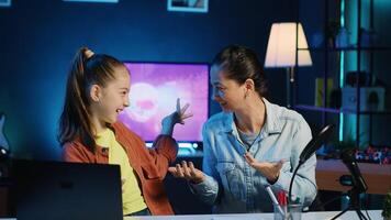Mom and her child filming for newly opened family channel. Gen Z media star and parent presenting themselves to audiences, informing them of topics they wish to explore in future clips photo