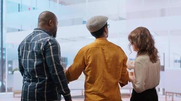 Business professionals and broker evaluating a property for corporate relocation, examining layout blueprints and discussing the architectural design. Planning an investment opportunity. Camera B. video