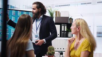 Financial advisor presenting investment strategies to customers using big screen, recommending stock exchange bonds. Broker in office assisting family with ipo forex portfolio management, camera A video