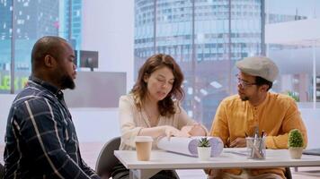 Real estate agent presenting the property investment opportunity available from leasing the new high class office space. Realtor evaluating blueprints and building layouts at desk. Camera A. video