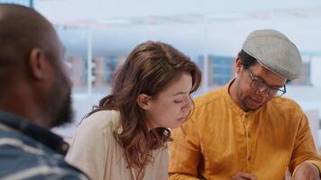 Corporate clients engage in a strategic planning session with a real estate agent, reviewing blueprints and discussing office space relocation to modern urban building. Investment strategy. Camera B. video