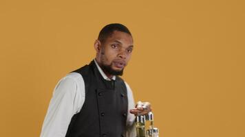 Professional waiter asking clients to wait a bit before serving them, working in a very busy restaurant. Employee trying to serve customers faster, showing professionalism in catering. Camera A. video