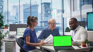 Financial banker works with a copy space on tablet with his elderly clients, showcasing retirement plans and pension options to secure their income and life savings. Insurance agency. Camera B. video