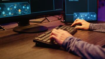 Hacker in secret underground shelter typing on keyboard, writing lines of code on computer, trying to get past security systems with virus. Scammer working on hacking script, close up shot photo