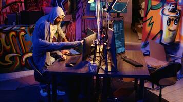 Hackers discussing plan on how to use network vulnerabilities to exploit servers, trying to break computer systems at night. Rogue programmers work together on breaching networks photo