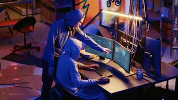Hackers in underground bunker working together to take advantage of security breach after gaining unauthorized access to system. Rogue programmers hacking network to steal government data photo
