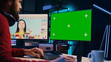 Freelancer working on green screen PC on digital portfolio showcasing photoshoot edited images. Photo editor selecting best photographs using retouching software interface on mockup monitor