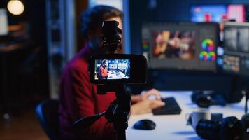 Photographer content creator using professional camera to record basic photography editing techniques guide for beginners, selling online course. Freelancer filming photo adjusting tutorial, zoom out