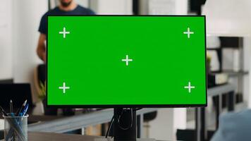 Worker analyzing greenscreen monitor and working on marketing revenue development. Businesswoman checking computer screen with isolated mockup chromakey, digital blank copyspace. photo