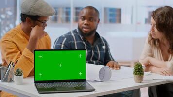 Contractors team showing office space sketch next to isolated chroma key, reviewing blueprint plans with a client. Real estate experts securing a contract after reaching a rental agreement. Camera B. photo