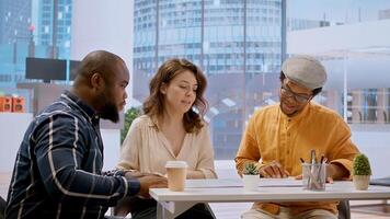Real estate agent presenting the property investment opportunity available from leasing the new high class office space. Realtor evaluating blueprints and building layouts at desk. Camera A. photo