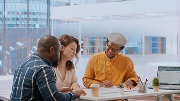 During an office tour, professional clients and realtor review blueprints and discuss investment strategy for modern workspace development. Strategizes layout of new urban office space. Camera B. photo