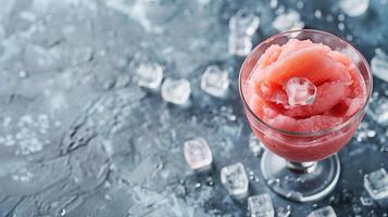 A cold sherbet in a glass with some ice cubes in it, copy space photo