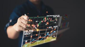 Use technology to plan strategy to success goals and growth stock.online business,online digital marketing.businessman draw graphs report and progress of business and analyze financial,and investment. photo