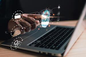 Businessmen protect personal data information from viruses on hand with virtual screen interfaces. Cyber security and privacy protection network security computer and safe data concept. photo