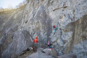Climbing in the mountains. A man climbs a rock. photo