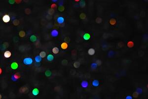 Abstract black background with bokeh of different colors. photo