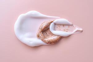 Cream and cream scrub on a pink background. Texture. photo