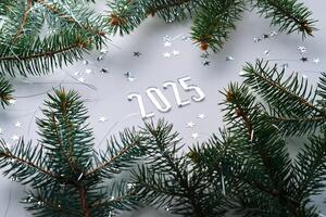 Abstract light Christmas background with stars and a Christmas tree with the year number 2025. photo