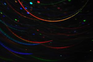 Abstract black background with bokeh of different colors. photo