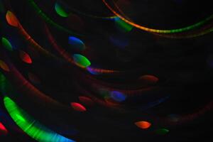 Abstract black background with bokeh of different colors. photo