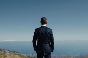 A businessman finds inspiration and motivation in a beautiful view, symbolizing success and reflection photo
