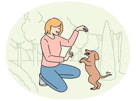 Smiling girl playing with dog in park vector
