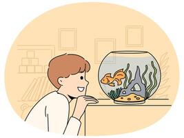 Smiling child look at goldfish in tank vector
