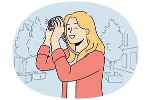 Smiling woman make photos with camera vector