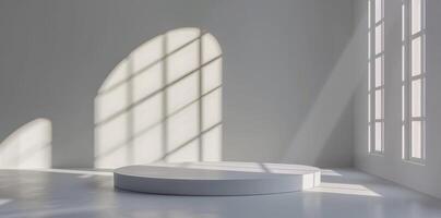 Sunlit white room with minimalist design, an empty podium casts shadow patterns for an artistic and tranquil ambiance photo