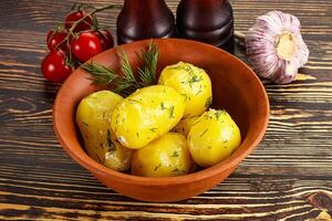 Boiled potato with oil and dill photo