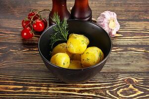 Boiled potato with oil and dill photo