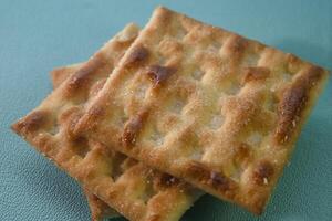 close up of cracker biscuit on green background photo