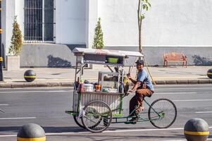 Bakso or Meatball street food seller traveling by trishaw on the streets of Surabaya, Indonesia, 20 June 2024. photo