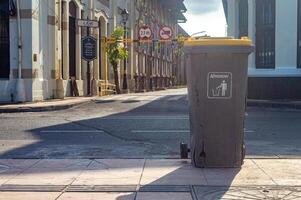 a trash can on the sidewalk on the side of a highway in Surabaya, Indonesia, 20 June 2024. photo