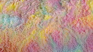 Culinary Composition, Vibrant Rainbow Ice Cream on Textured Surface, Top View with Copy Space photo