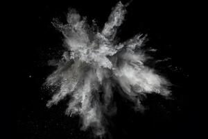 Capture of White Powder Bursting in Freeze Frame on Black Surface photo