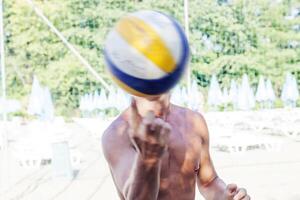 portrait of volleyball player while keeping balancing ball on a finger photo