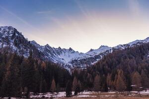 panoramic sunset views of the snowy peaks of the Italian Alps photo
