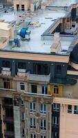 Construction of a tall building in the city. Modern block of flats builds in the city. New tower architecture with windows. Aerial view. Vertical video