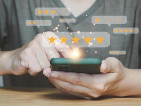 Customer satisfaction survey concept Users rate service experience on online applications. Through a smartphone, a five-star satisfaction rating The system is very satisfied photo