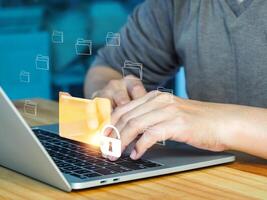 man using laptop with folder icon on screen photo