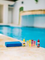 Chlorine and ph tester for swimming pools. Water test kit on the edge of the swimming pool. Chlorine test kit for swimming pools photo