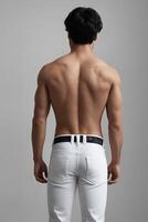 Muscular Back View of Man in Jeans on Gray Background photo