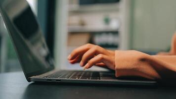 Cropped image of professional businesswoman working at her office via laptop, young female manager using portable computer device while sitting at modern loft, flare light, work process concept video