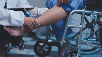Physical therapist helps a male patient use a walker to practice walking. Support yourself from recovery from sore legs and ankles. Physical therapy service concept. video