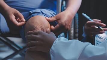 Physical therapist helps a male patient use a walker to practice walking. Support yourself from recovery from sore legs and ankles. Physical therapy service concept. video